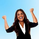 Excited Businesswoman With Clenched Fists Stock Photo