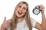 Excited Girl Holding Old Fashioned Alarm Clock Stock Photo