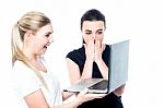 Excited Girls Watching Videos On Laptop Stock Photo