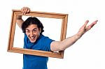 Excited Man Holding Picture Frame Stock Photo