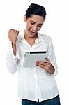 Excited Pretty Woman Using Tablet Pc Stock Photo