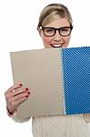 Excited Teen Girl Holding Note Book Close To Her Stock Photo