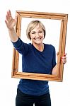 Excited Woman Holding Picture Frame Stock Photo