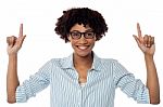 Excited Woman Pointing Upwards Stock Photo