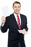 Executive Showing Blank Playing Card To Camera Stock Photo