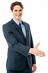 Executive Welcoming You With A Handshake Stock Photo