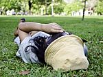 Exhausted Student Over The Grass Stock Photo