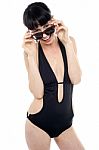 Exotic Woman In Black Bikini Peeking Through Her Sunglasses Stock Photo