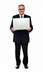 Experienced Business Person Holding Laptop Stock Photo