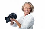 Experienced Female Photographer With Camera Stock Photo