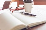 Eyeglasses With Coffee Cup In Coffee Shop Stock Photo