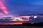 Factory Beside The Sea With Colorful Sunset Stock Photo