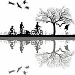 Family Cycling On Edge Of Lake Stock Photo