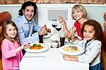 Family Eating Together In A Restaurant Stock Photo