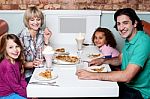 Family Eating Together In A Restaurant Stock Photo