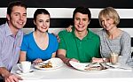 Family Enjoying Dinner At A Restaurant Stock Photo