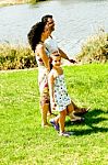 Family Holding Hands While Walking Stock Photo