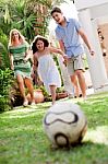 Family Members Playing Soccer Stock Photo