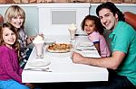 Family Of Four Posing To Camera Stock Photo