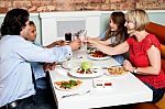 Family Raising A Toast Before Dinner Stock Photo