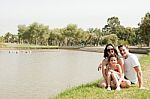 Family Sitting Near The Lake Stock Photo