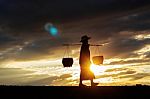 Farmers Are Walking At Sunset Stock Photo