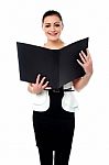 Fashionable Businesswoman Reviewing A File Stock Photo