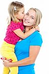 Fashionable Young Kid Kissing Her Mother Stock Photo