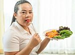 Fat Woman Eating Salad Stock Photo