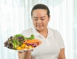 Fat Woman Eating Salad Stock Photo