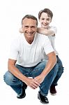 Father And Son Sitting On Floor Stock Photo