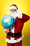 Father Christmas Showing His Country On Globe Stock Photo