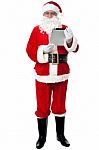 Father Christmas Using New Tablet Device Stock Photo