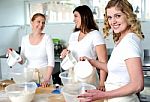 Female chefs holding jug Stock Photo