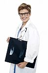 Female Doctor Holding X-ray Report Stock Photo