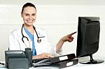 Female Doctor Pointing Screen Stock Photo