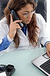 Female Doctor Talking On Cell Phone Stock Photo