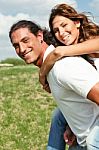 Female Enjoying Piggy Ride Stock Photo