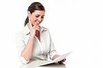 Female Executive Analyzing Business Reports Stock Photo