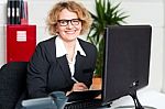 Female Executive Writing Notes On Clipboard Stock Photo