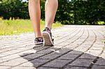 Female Feet On The Sidewalk Closeup Stock Photo