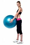 Female Fitness Trainer Holding Swiss Ball Stock Photo