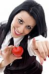 Female Holding A Red Heart Pointing At Camera Stock Photo