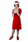 Female In Santa Cap Using Tablet Pc Stock Photo