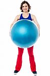 Female Instructor Displaying Pilates Ball Used In Gym Stock Photo