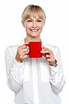 Female Manager Posing With Coffee Mug In Hand Stock Photo