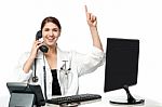 Female Physician Answering Phone Call Stock Photo