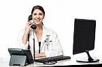 Female Physician Answering Phone Call Stock Photo