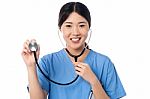 Female Physician Posing With Stethoscope Stock Photo