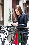 Female Shopper Texting Stock Photo